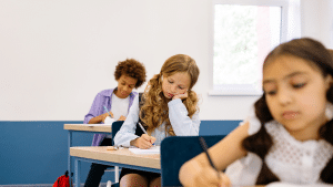 Children sitting at desks in classroom