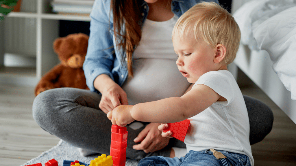Mother and son playing on the floor with legos