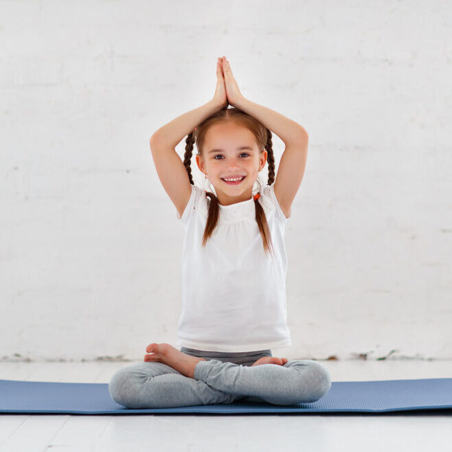 child girl doing yoga and gymnastics in the gym