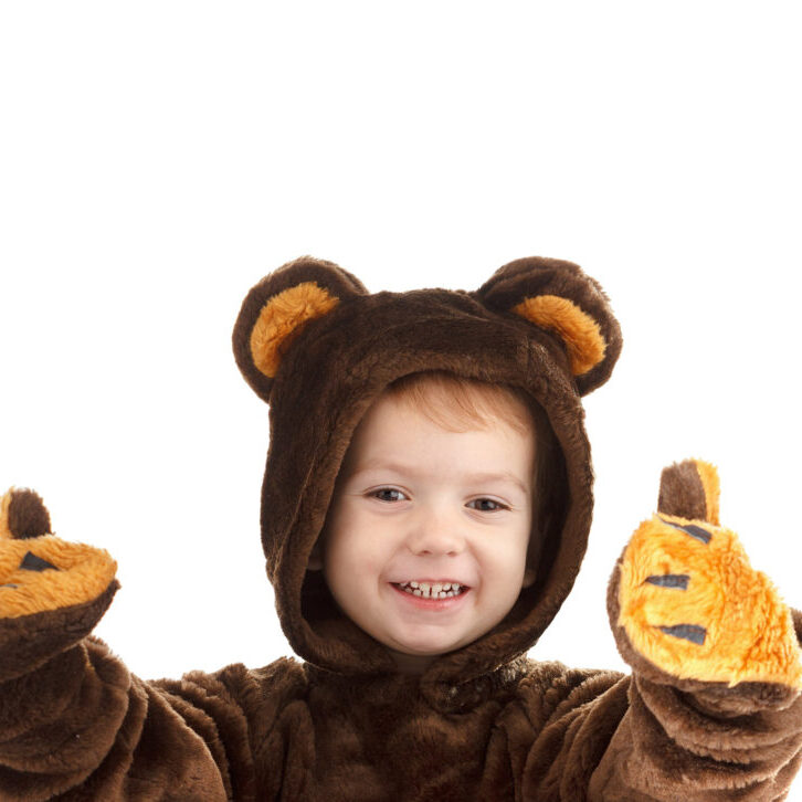 Child in a christmas carnival bear costume isolated on white background with copy space,  carnival.