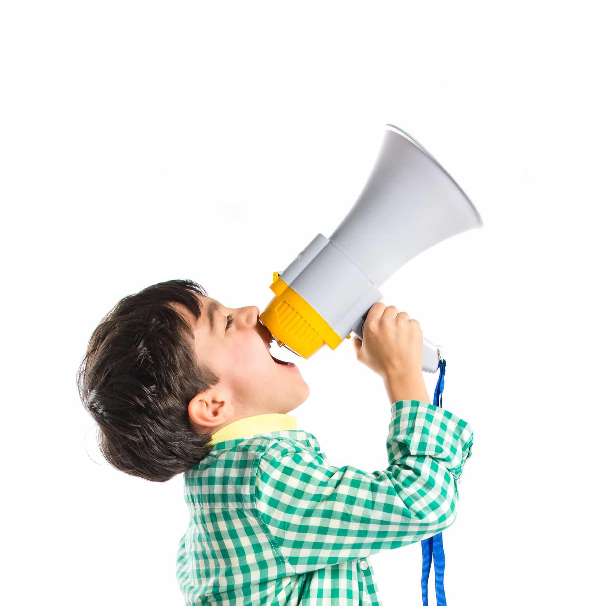 Kid shouting by megaphone over white background