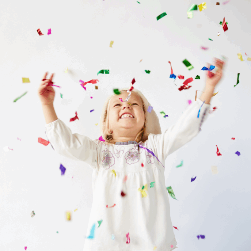 Child with Down Syndrome holding "21"
